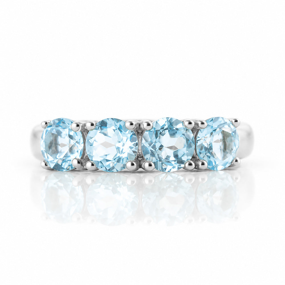 Celine, a Sky Blue Topaz Four Stone Half Eternity Ring