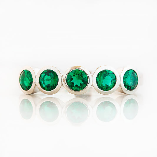 Violet, a Lab Emerald Bezel Set Half Eternity Ring