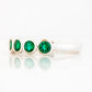 Violet, a Lab Emerald Bezel Set Half Eternity Ring