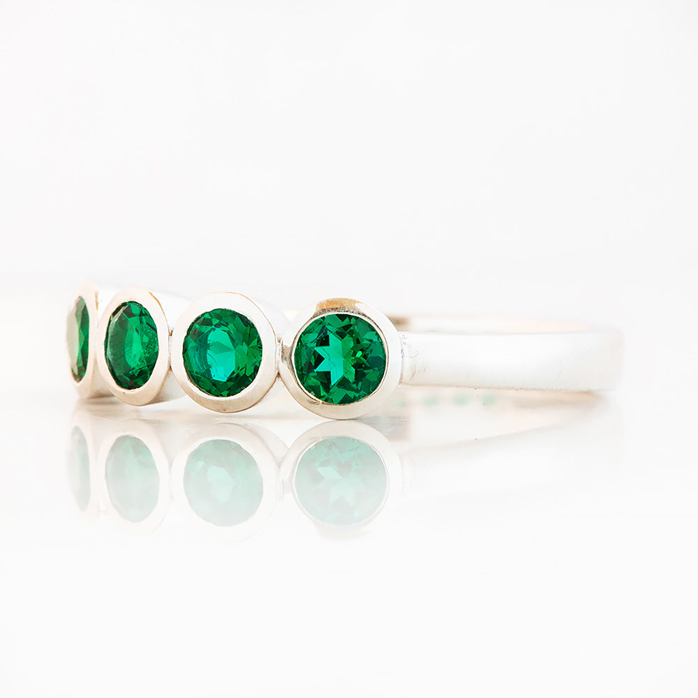 Violet, a Lab Emerald Bezel Set Half Eternity Ring