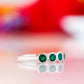 Violet, a Lab Emerald Bezel Set Half Eternity Ring