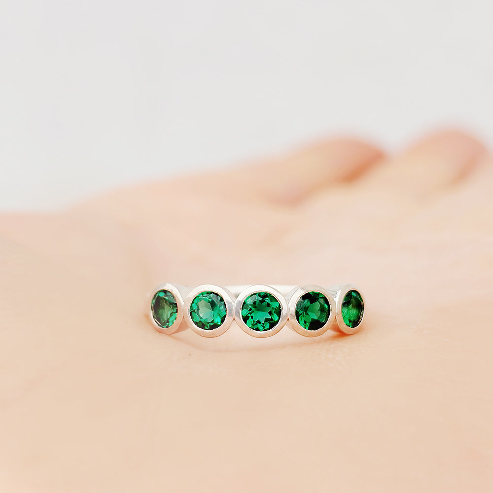 Violet, a Lab Emerald Bezel Set Half Eternity Ring