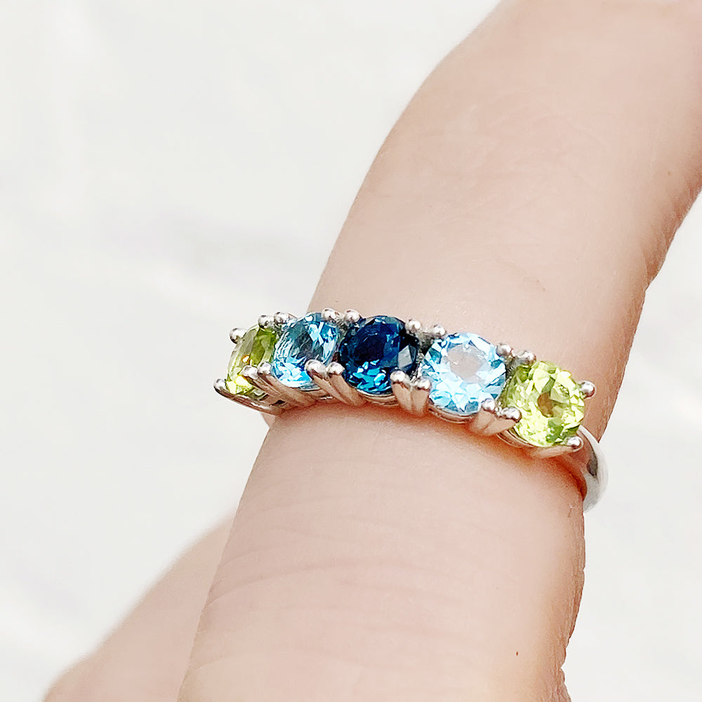 Annie, a Peridot and Topaz Half Eternity Ring