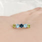 Annie, a Peridot and Topaz Half Eternity Ring