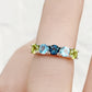 Annie, a Peridot and Topaz Half Eternity Ring