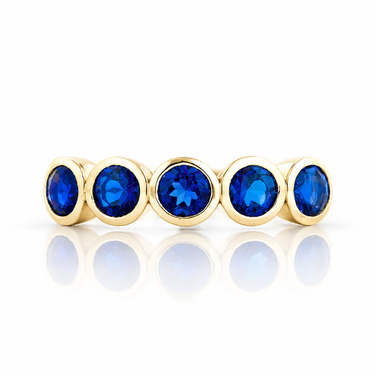 Violet, a Lab Sapphire Bezel Set Half Eternity Ring