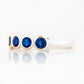 Violet, a Lab Sapphire Bezel Set Half Eternity Ring