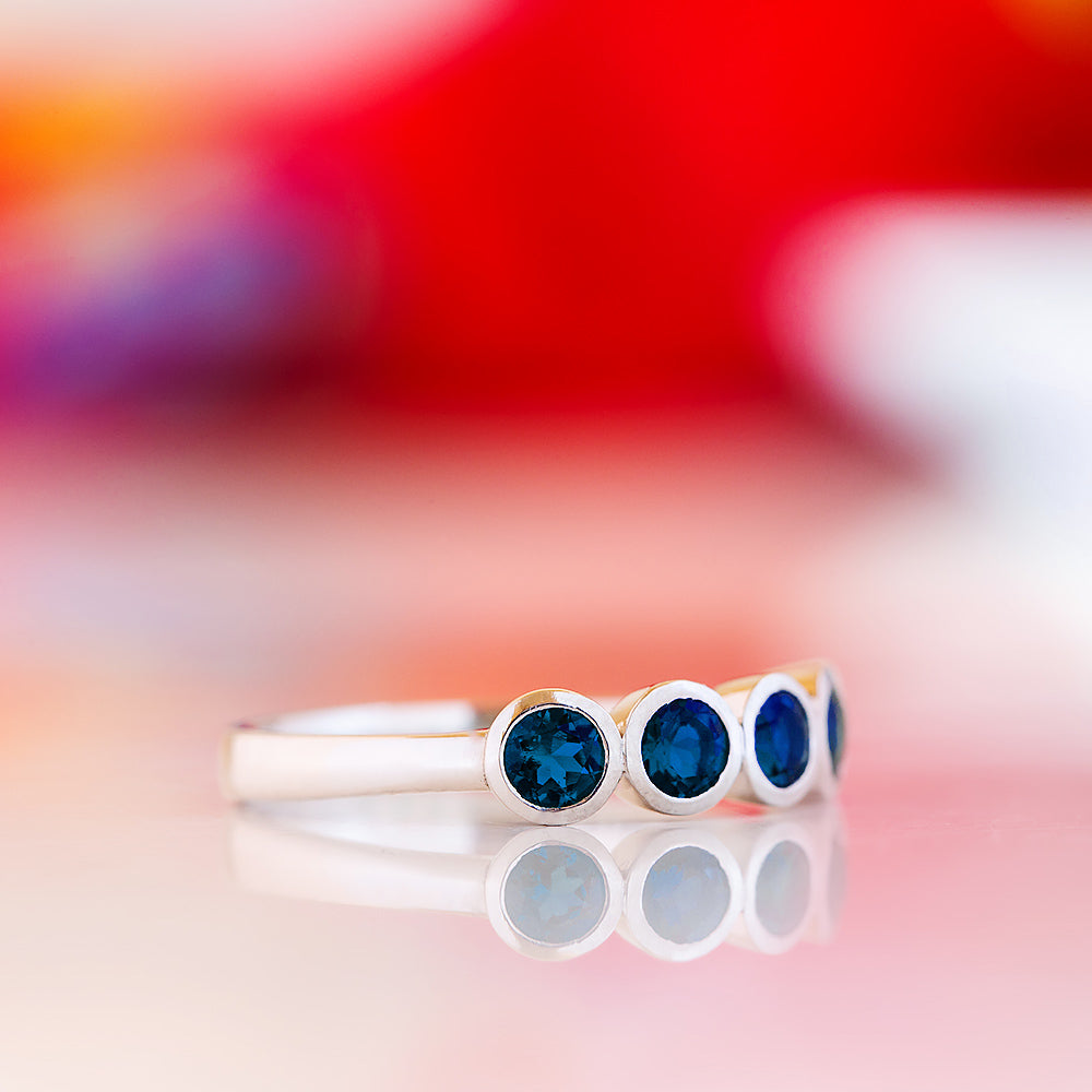 Violet, a Lab Sapphire Bezel Set Half Eternity Ring