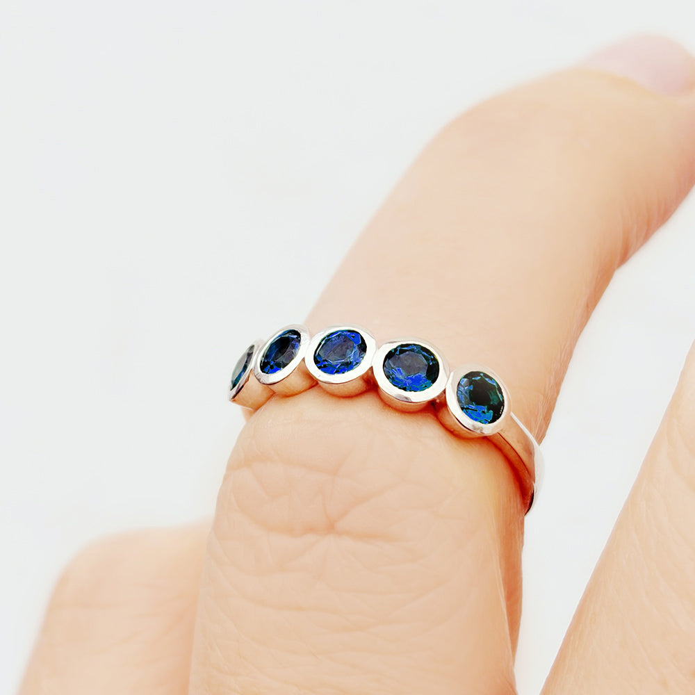 Violet, a Lab Sapphire Bezel Set Half Eternity Ring