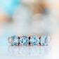 Celine, a Sky Blue Topaz Four Stone Half Eternity Ring