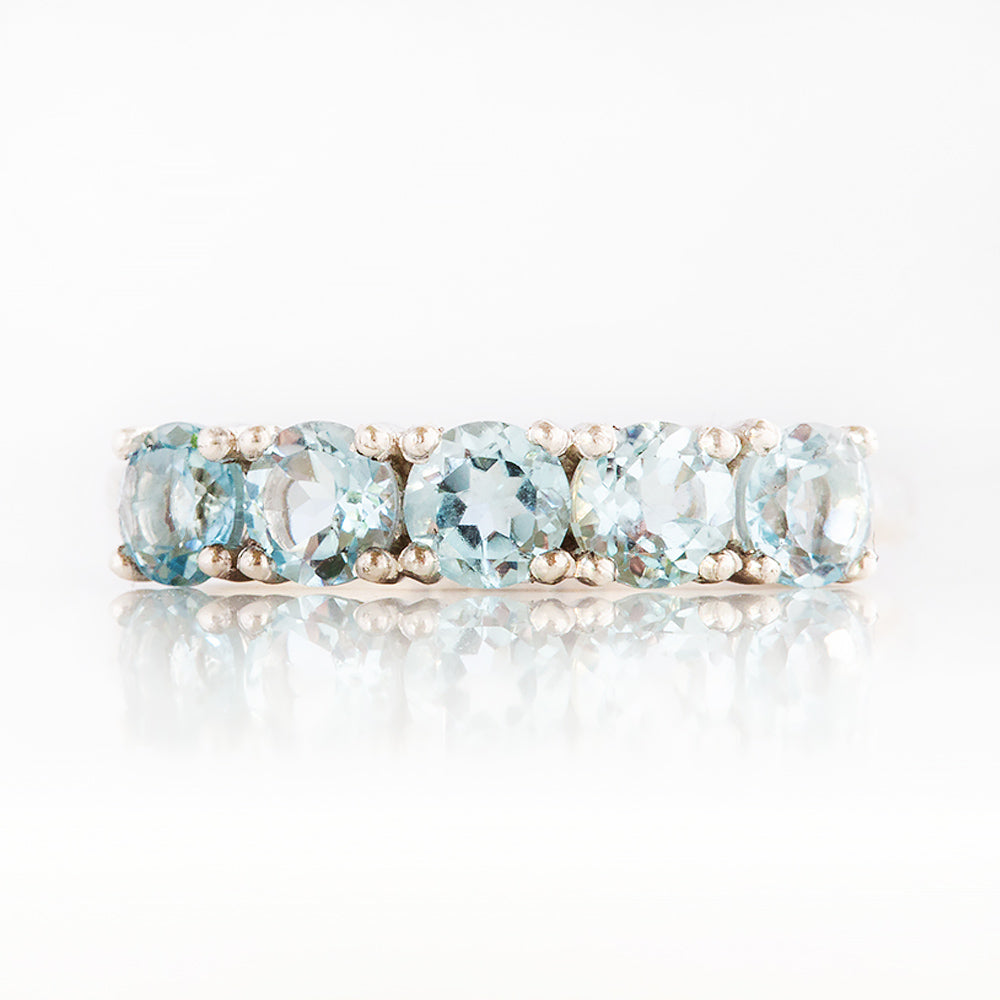 Annie, a Sky Blue Topaz Half Eternity Ring