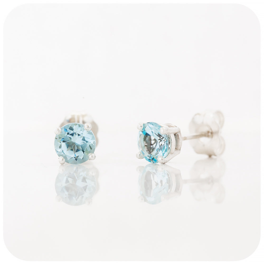 round cut light sky blue topaz stud earrings in sterling silver