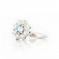 Fleur, a Moissanite and Topaz Flower Cluster Ring