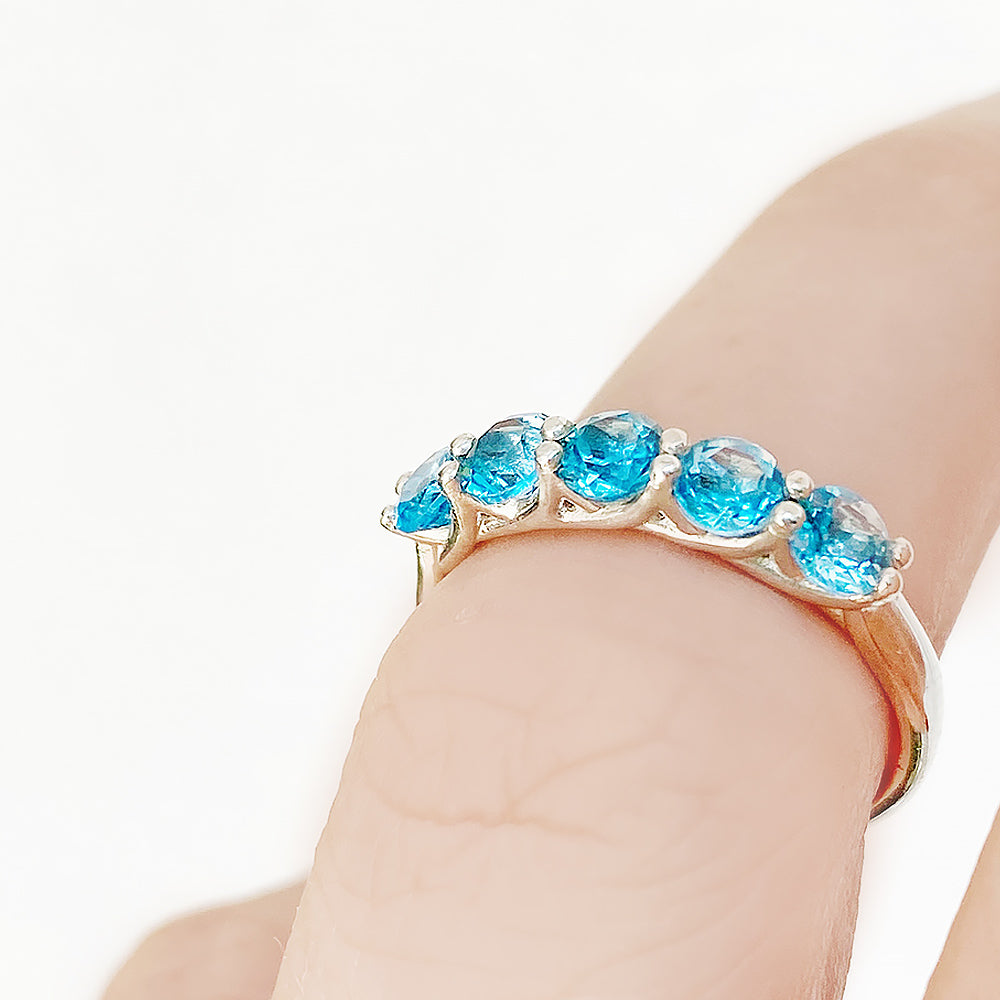 Danelle, a Swiss Blue Topaz Half Eternity Trellis Ring