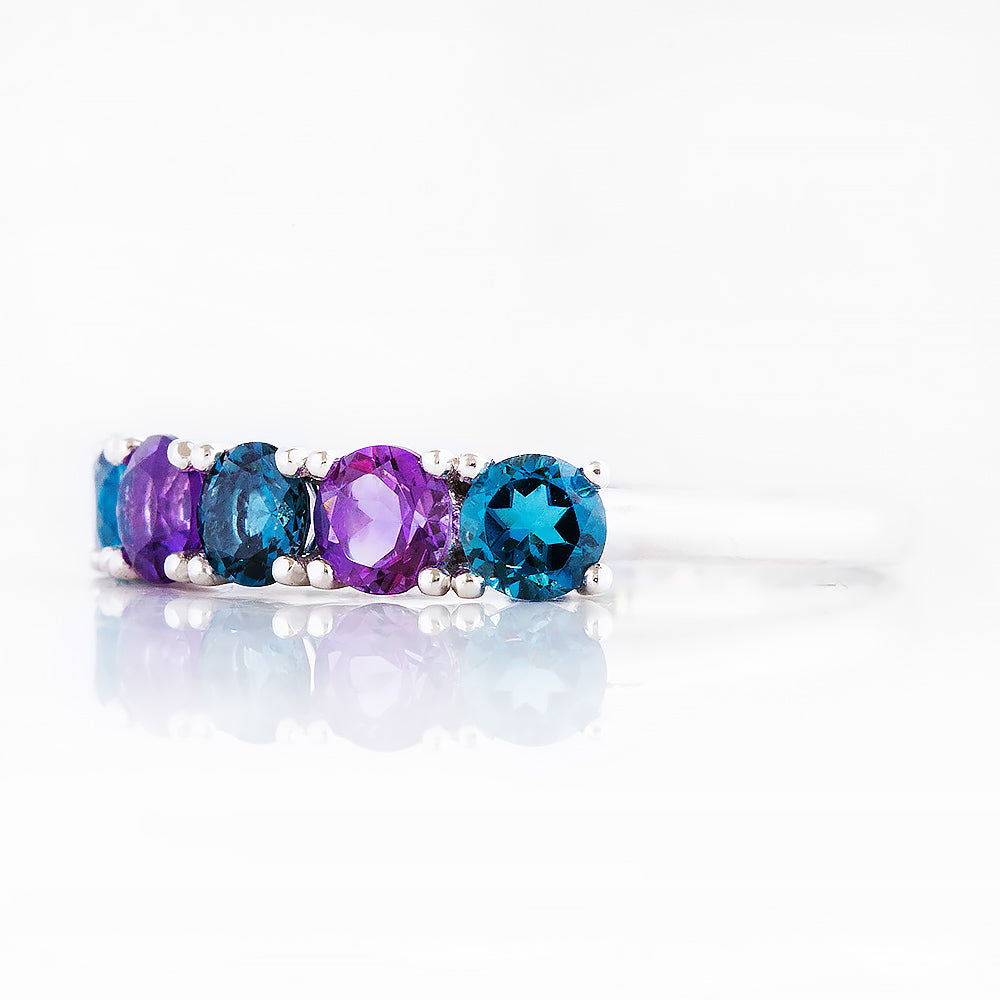 Annie, a London Topaz and Amethyst Half Eternity Ring