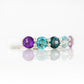 Danelle, a Topaz and Amethyst Rainbow Half Eternity Trellis Ring