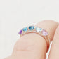 Danelle, a Topaz and Amethyst Rainbow Half Eternity Trellis Ring
