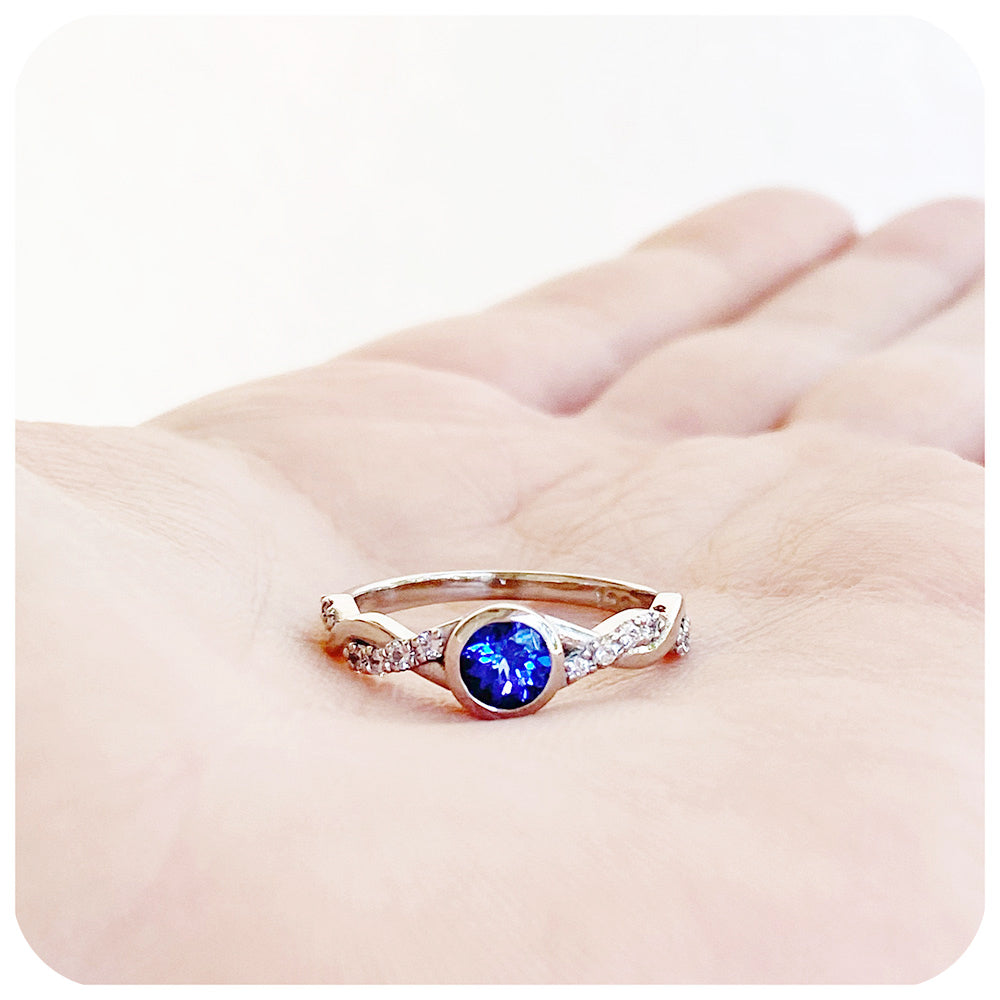 tanzanite and moissanite infinity style wedding ring