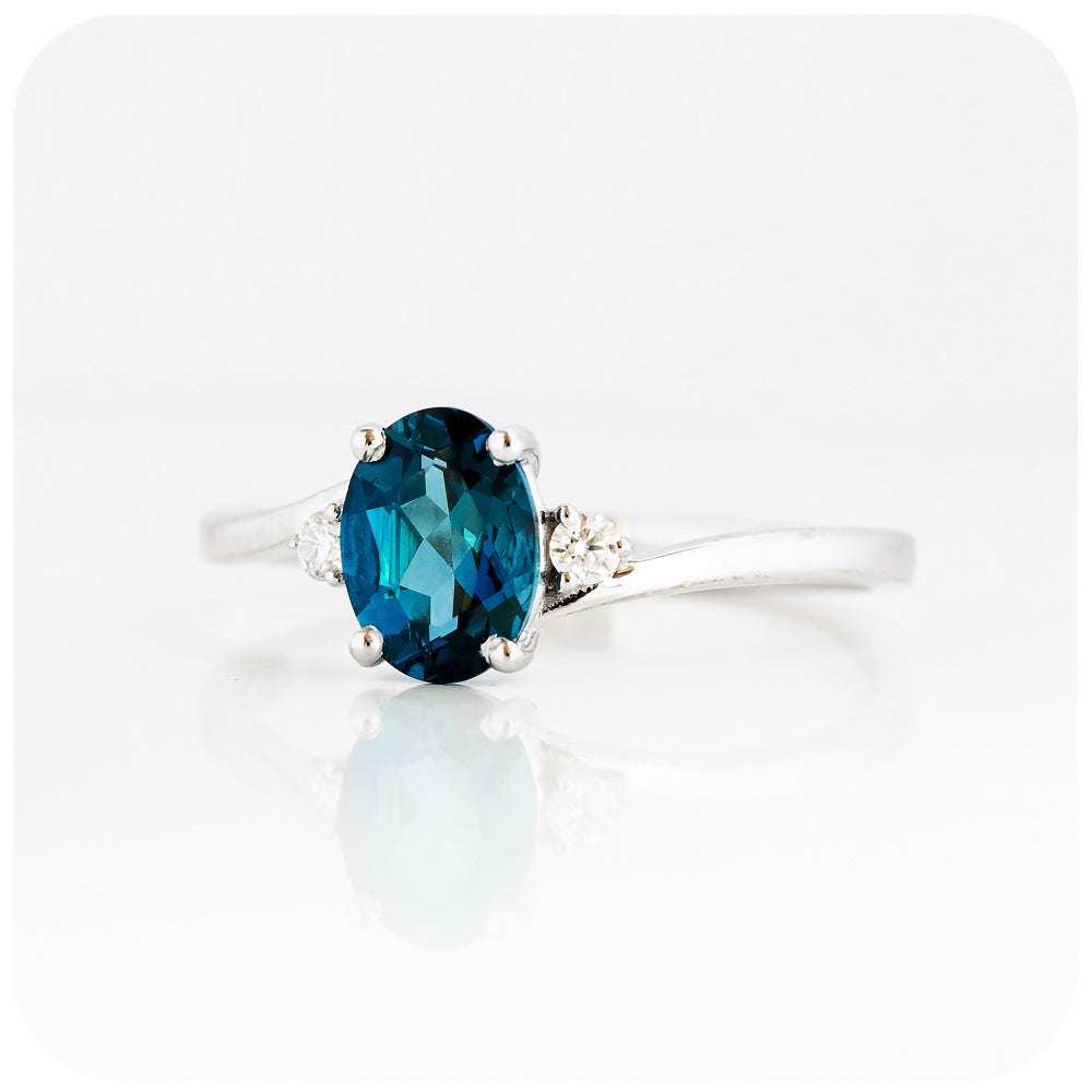 Oval cut London Blue Topaz  and Moissanite Trilogy Ring with a Twist - 8x6mm