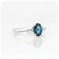 Oval cut London Blue Topaz and Moissanite Trilogy Ring with a Twist