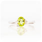 Oval cut Peridot and Moissanite Trilogy Ring with a Twist