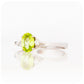 Oval cut Peridot and Moissanite Trilogy Ring with a Twist