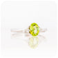 Oval cut Peridot and Moissanite Trilogy Ring with a Twist