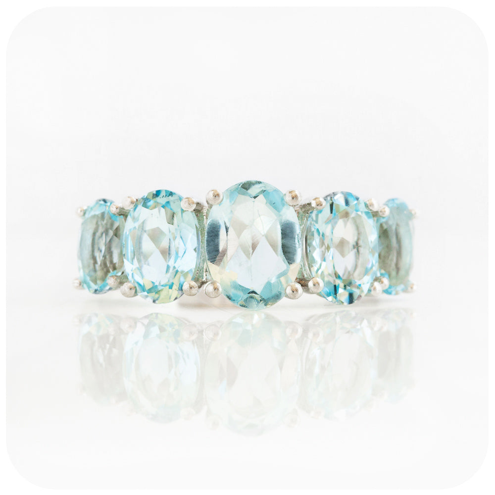 oval cut graduated sky blue topaz half eternity anniversary or birthstone ring