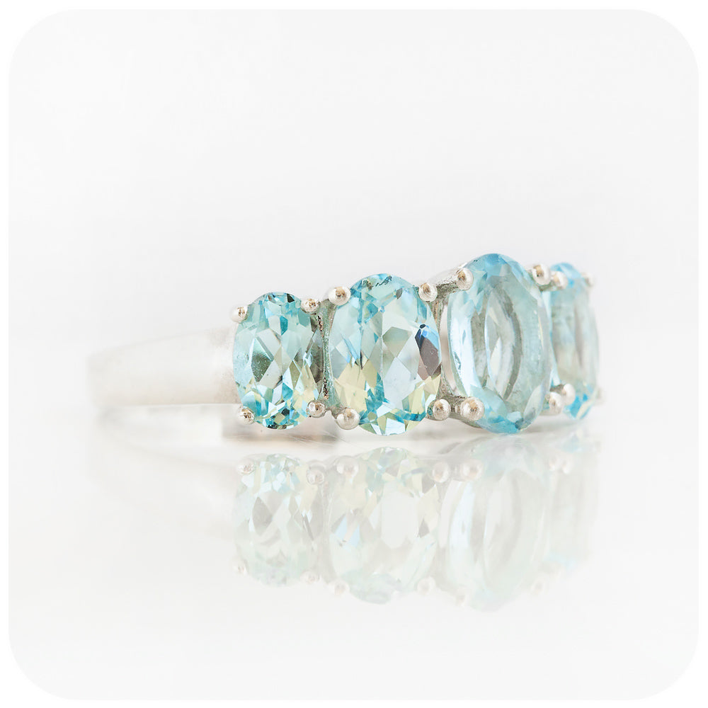 oval cut graduated sky blue topaz half eternity anniversary or birthstone ring