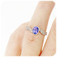 oval cut tanzanite and cubic zirconia twisted band ring in sterling silver