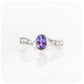 oval cut tanzanite and cubic zirconia twisted band ring in sterling silver