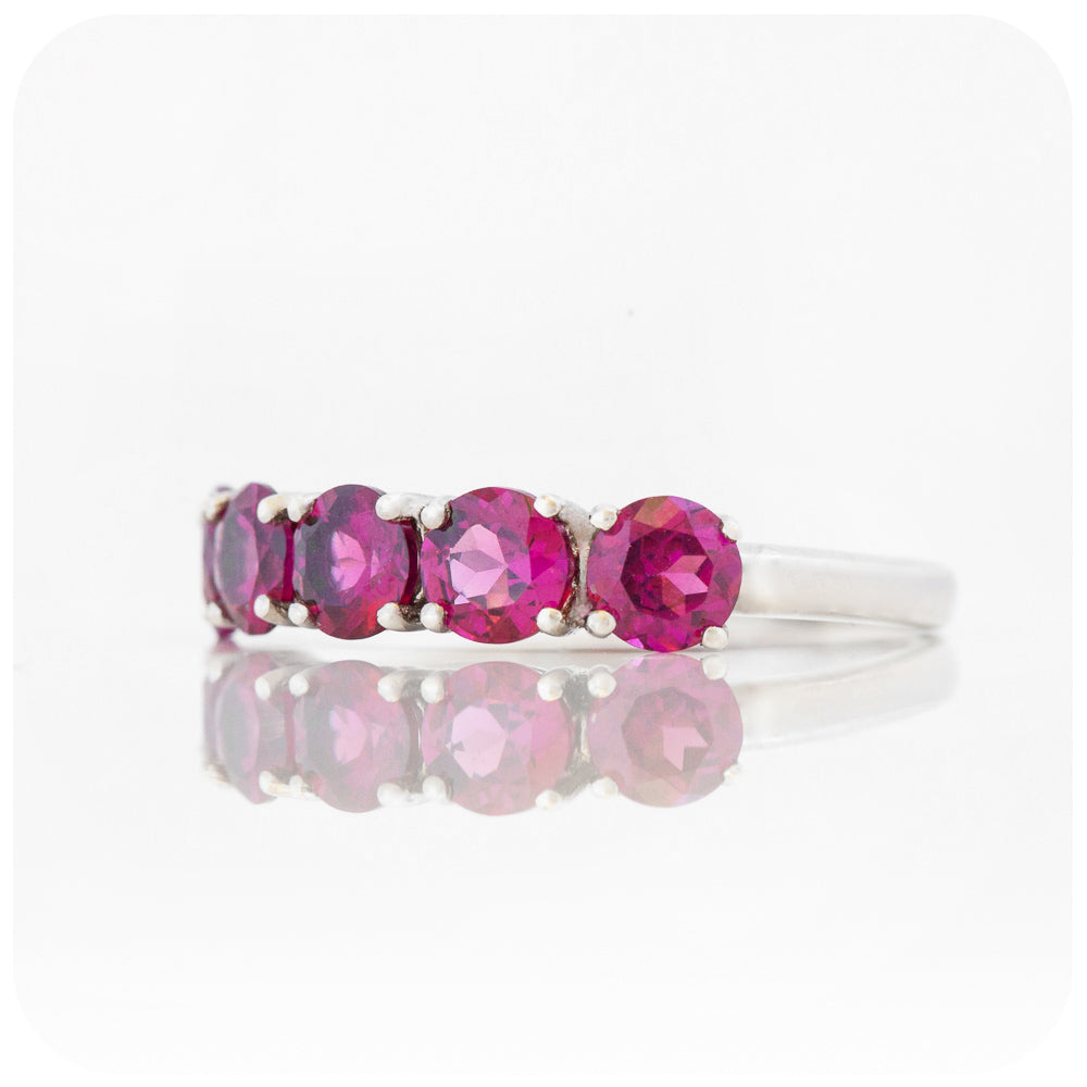 pinkish red rhodolite garnet half eternity ring with round cut stones