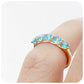 Danelle, a Swiss Blue Topaz Half Eternity Trellis Ring