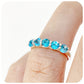 Danelle, a Swiss Blue Topaz Half Eternity Trellis Ring