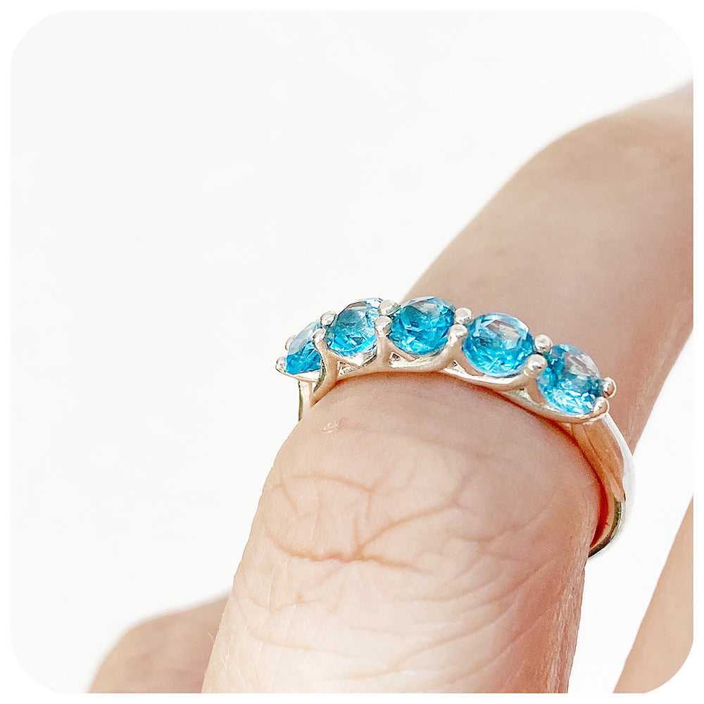 Danelle, a Swiss Blue Topaz Half Eternity Trellis Ring