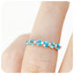 The Ellie, a Swiss Blue Topaz Six Stone Half Eternity Ring