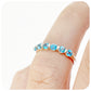 The Ellie, a Swiss Blue Topaz Six Stone Half Eternity Ring