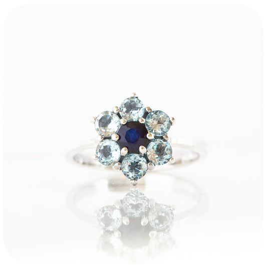 sapphire and topaz cluster style ring in a flower design