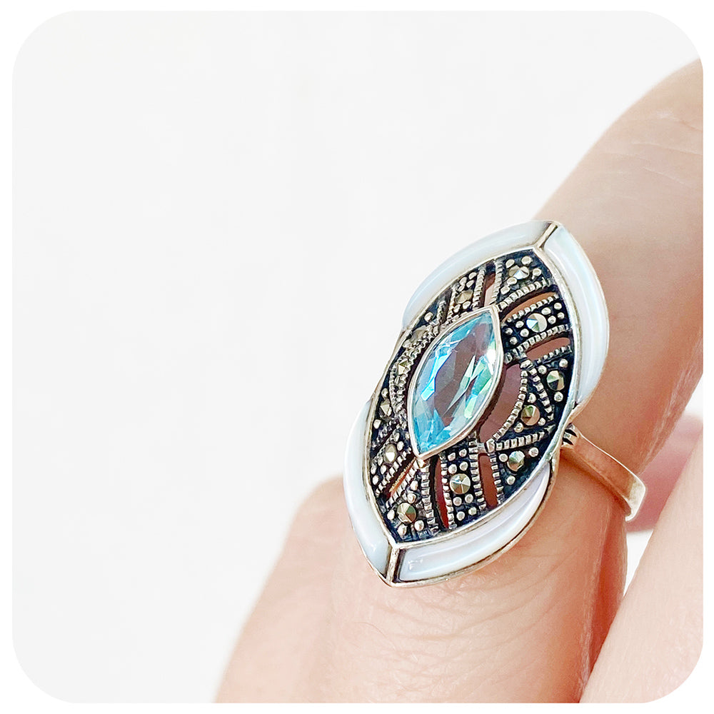 mother of pearl and blue topaz cocktail ring