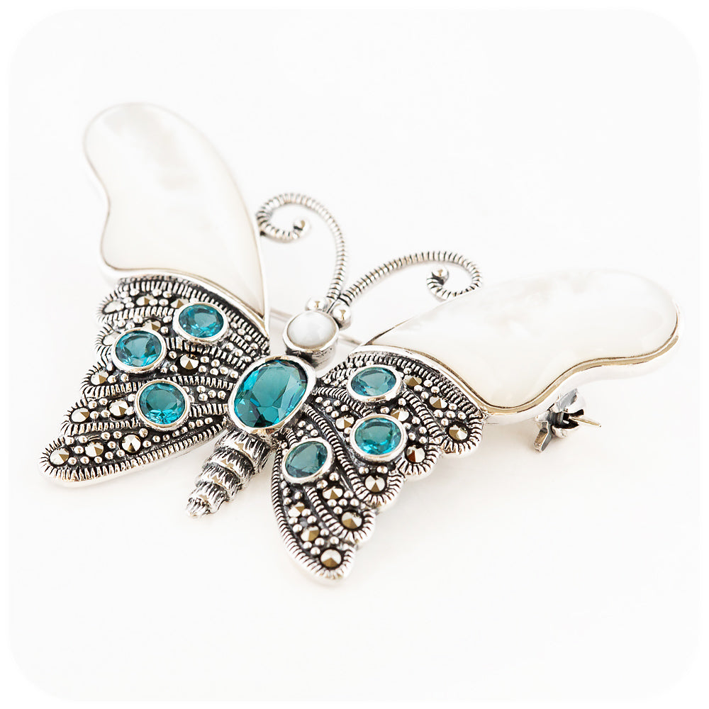 The Butterfly, a Mother of Pearl and London Blue Topaz Brooch