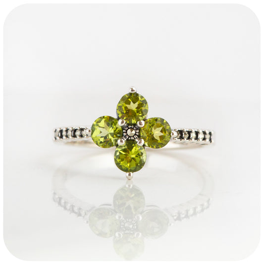 round cut green peridot flower cluster ring in a vintage style