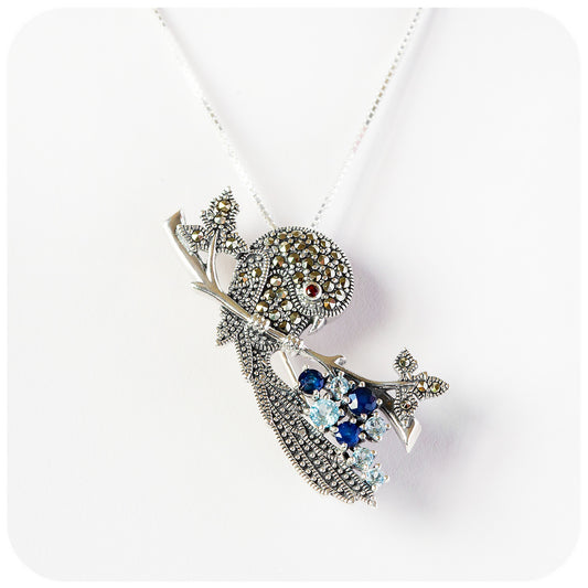 The Blueberry Bird, a Pendant and Brooch with Topaz and Sapphire