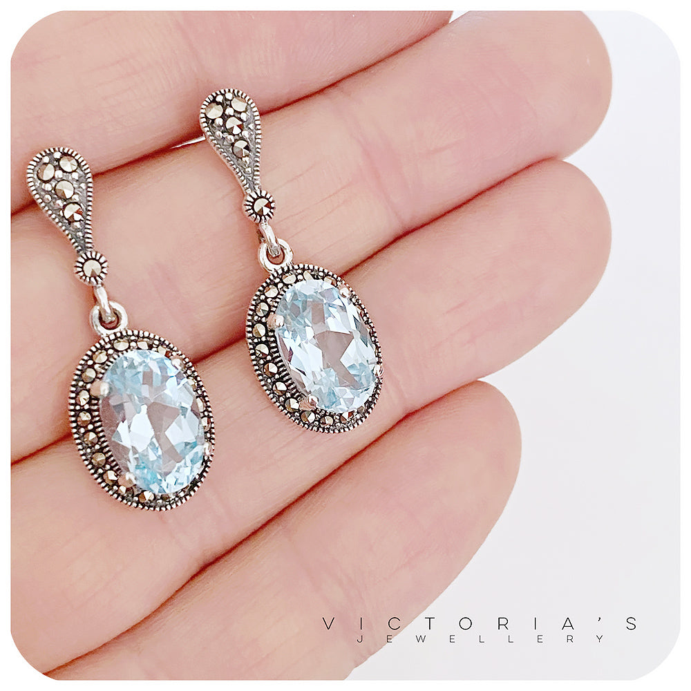 oval sky blue topaz november birthstone stud earrings in a vintage halo sterling silver setting - Victoria's Jewellery
