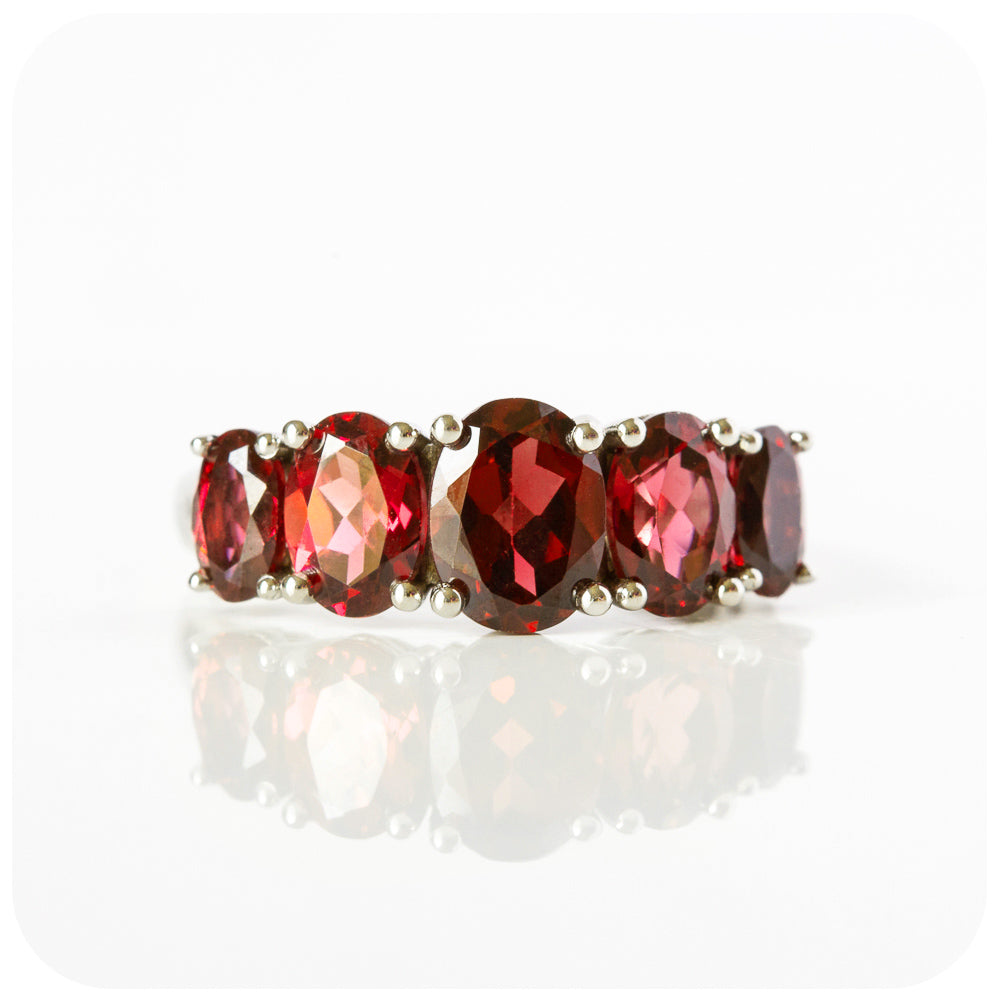 oval cut red garnet half eternity anniversary or birthstone ring