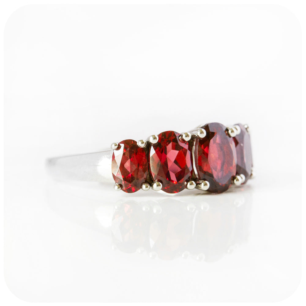 oval cut red garnet half eternity anniversary or birthstone ring