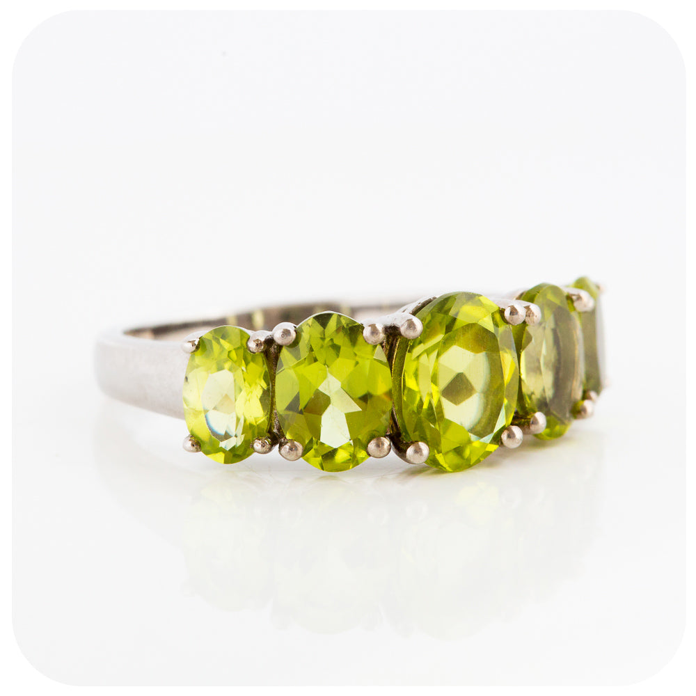 oval cut green peridot half eternity anniversary ring