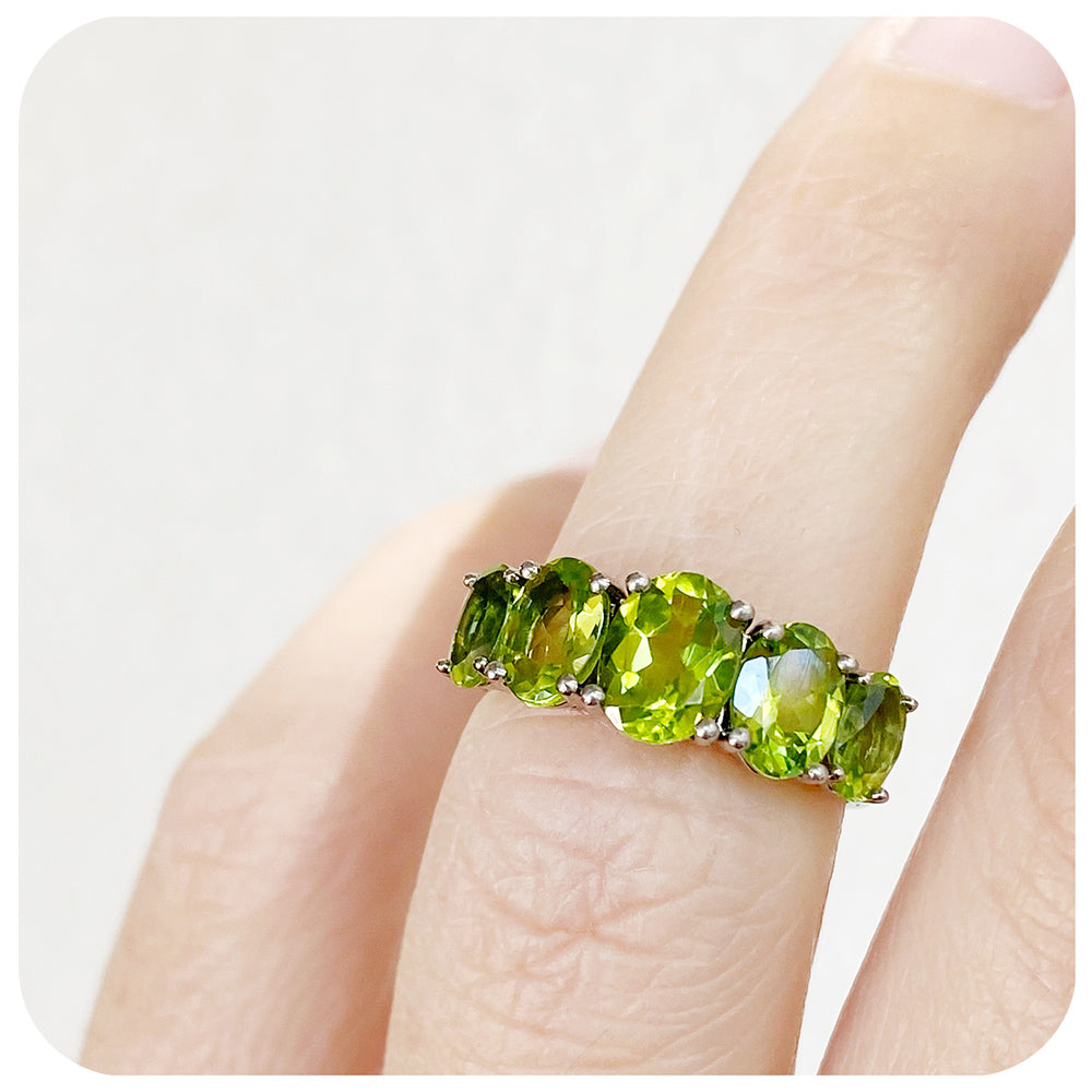 oval cut green peridot half eternity anniversary ring