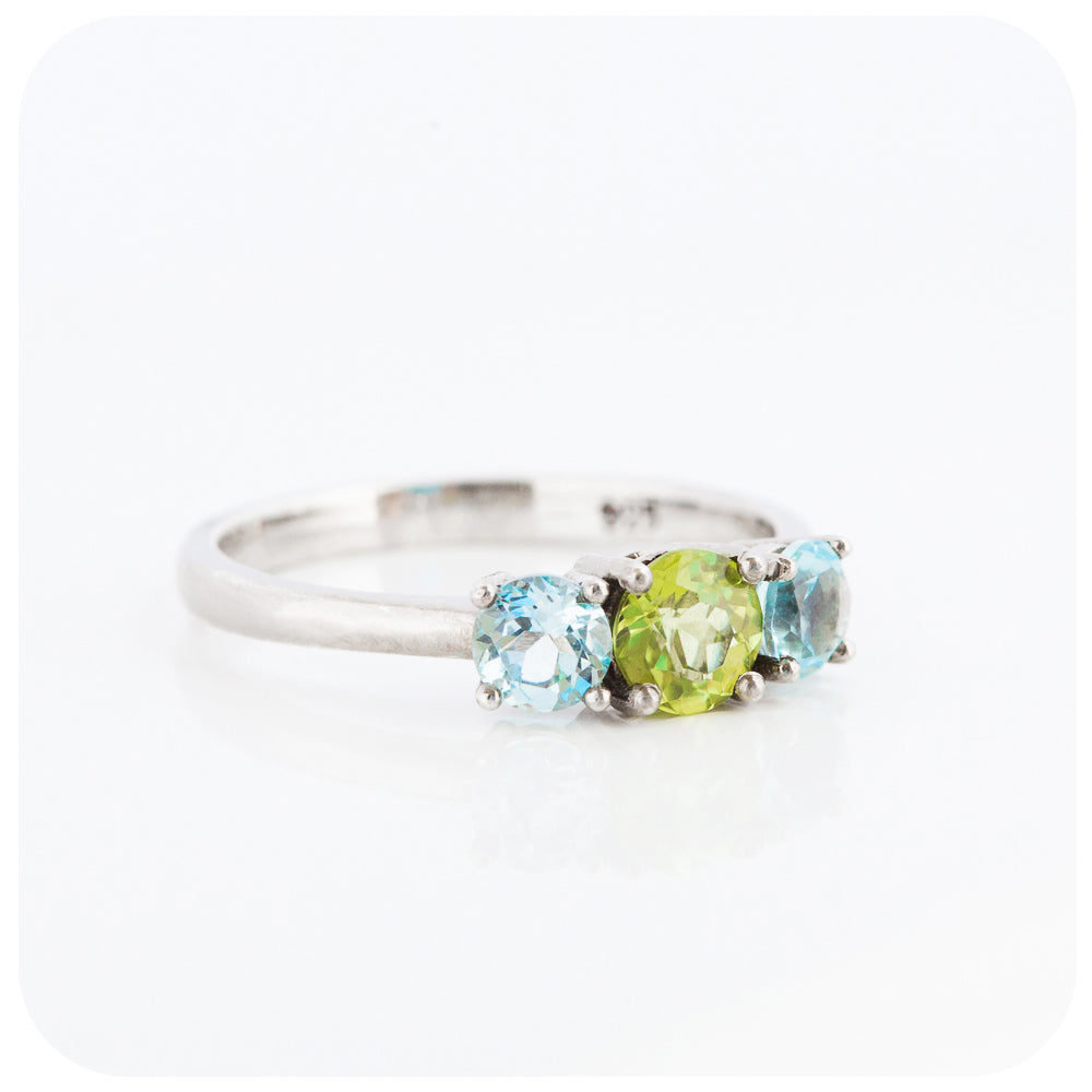 Peridot and Sky Blue Topaz Round cut Trilogy Ring