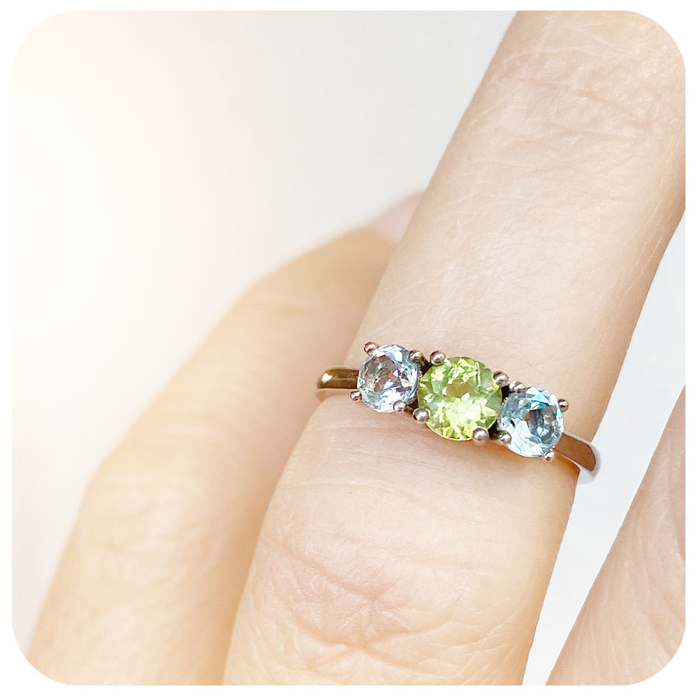 Peridot and Sky Blue Topaz Round cut Trilogy Ring