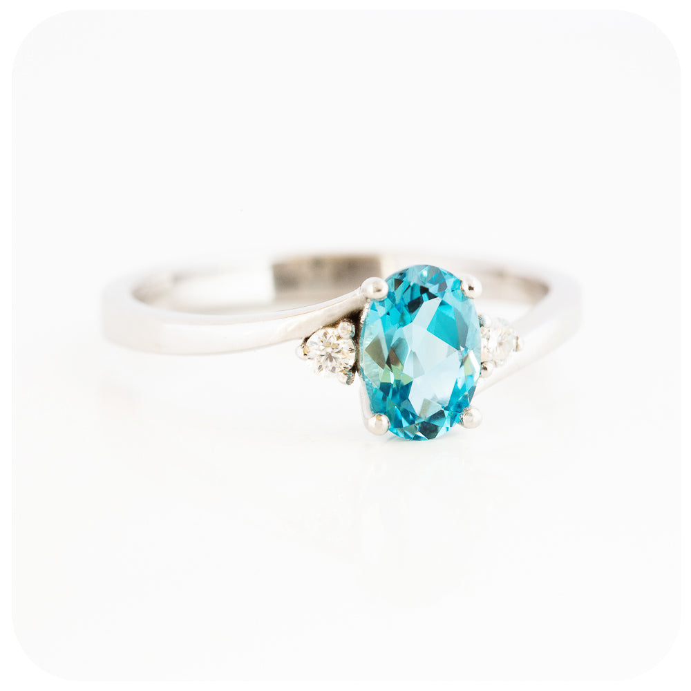 Oval cut Swiss Blue Topaz and Moissanite Trilogy Ring with a Twist